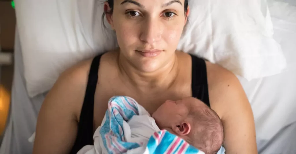 A couple lovingly prepares for the arrival of their baby. They are arranging baby clothes and decorating the nursery with pastel colors and soft toys. The atmosphere is warm and joyful, with the expectant mother glowing with happiness and the father tenderly holding a tiny onesie.